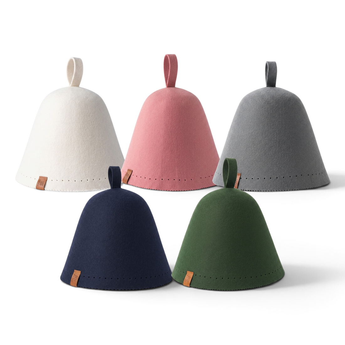 Five merino wool sauna hats arranged in two rows: cream, pink and gray behind navy and forest